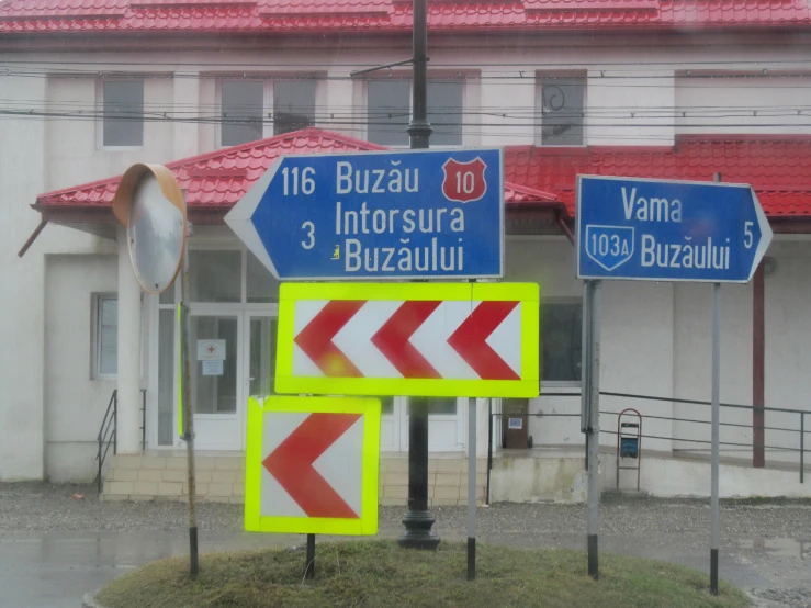 a bunch of street signs in front of a building