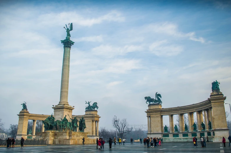 a fountain has statues on it in the city