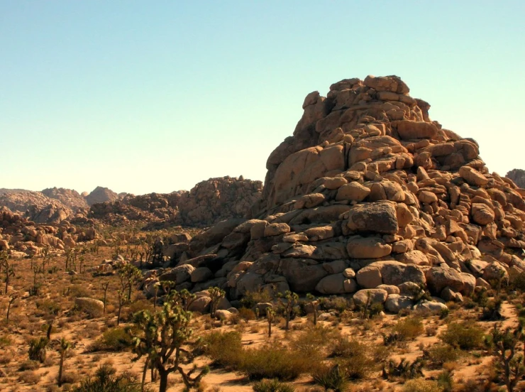 a very big rock structure in the middle of a desert