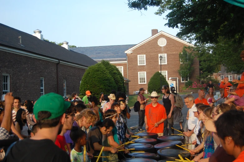 a lot of people in a crowd with a big set of blue frisbees