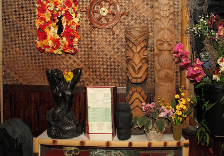 a table with flowers and two vases of flowers