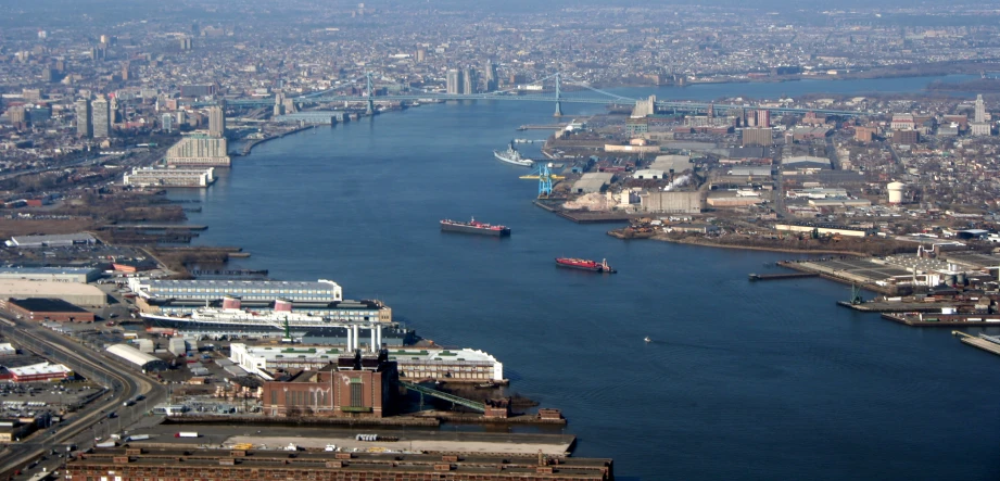 aerial po of river with boats sailing down it