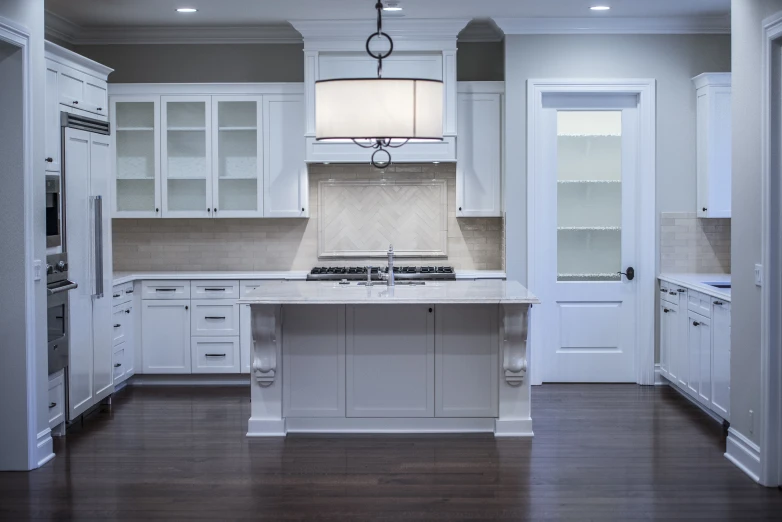 a very big nice looking kitchen with white cabinets