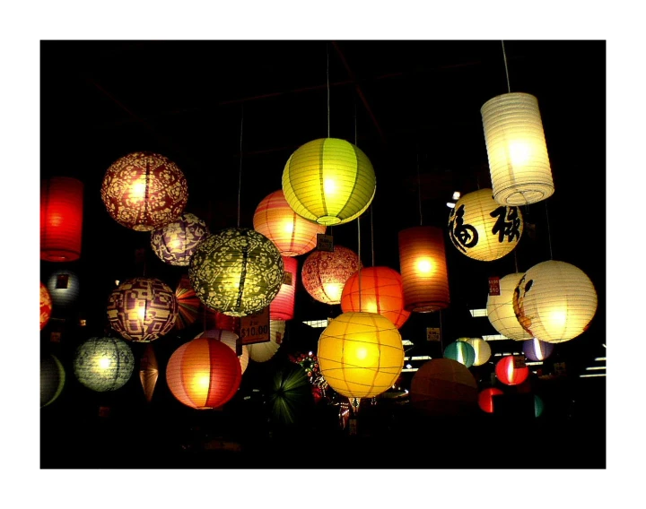 a group of lit up chinese lanterns are shown