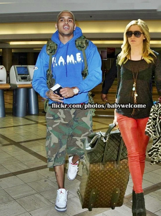 a man and woman walking in an airport