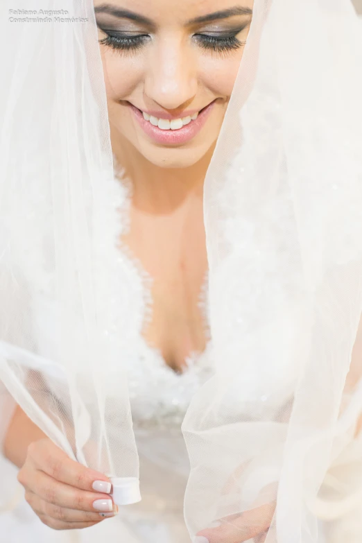 a smiling bride with white veil and hair