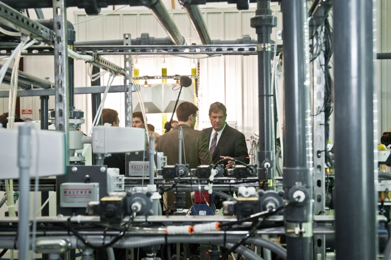 an industrial assembly line with men working on a machine