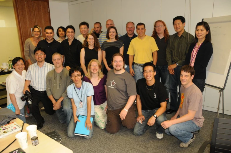 a large group of people are posing for a group po