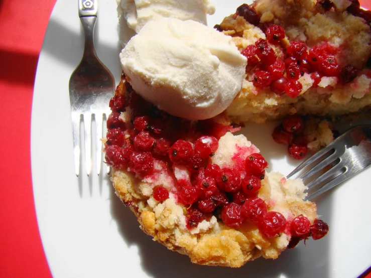 a fork and a raspberry dessert on a plate