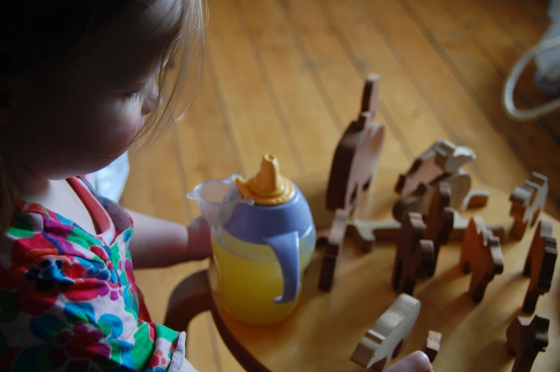 a small child playing with wooden blocks on the floor