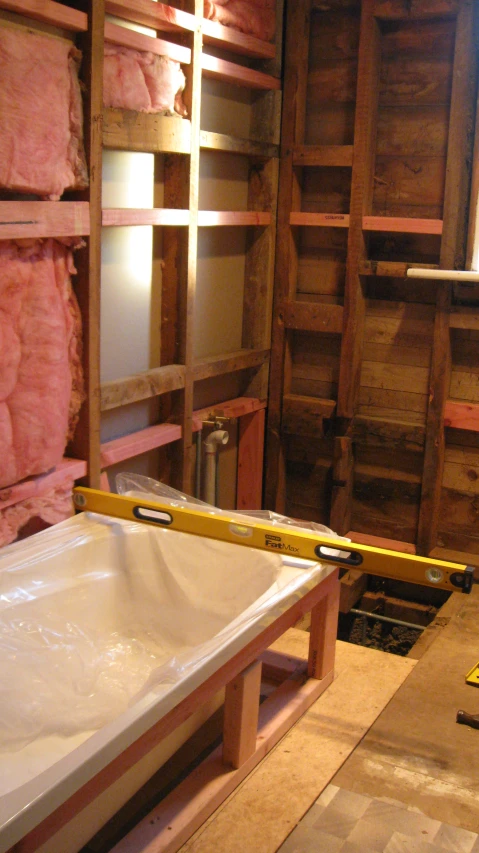 a sink in a room under construction on pallets