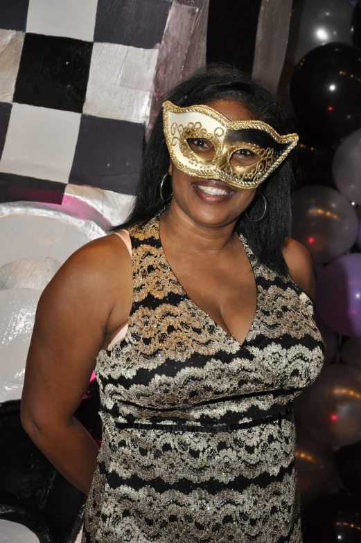woman with a golden mask on her face posing for the camera