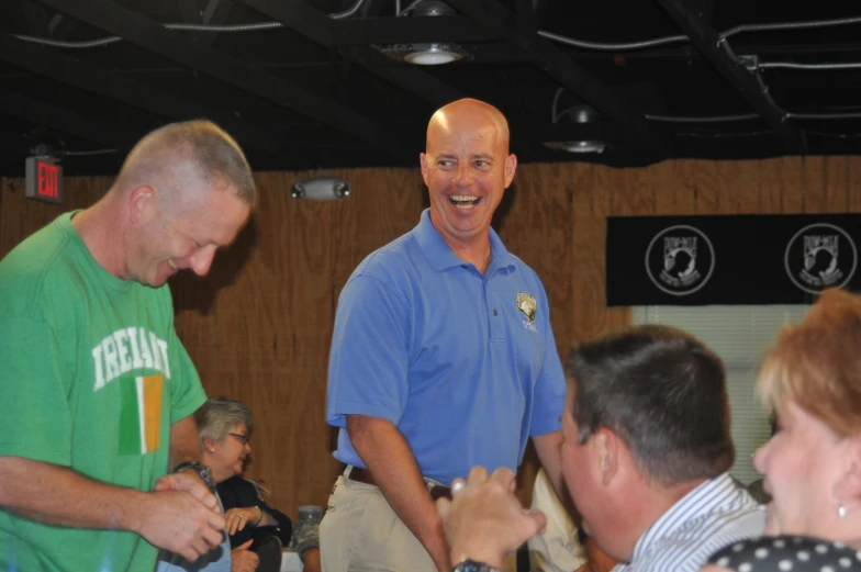 three men standing next to each other smiling