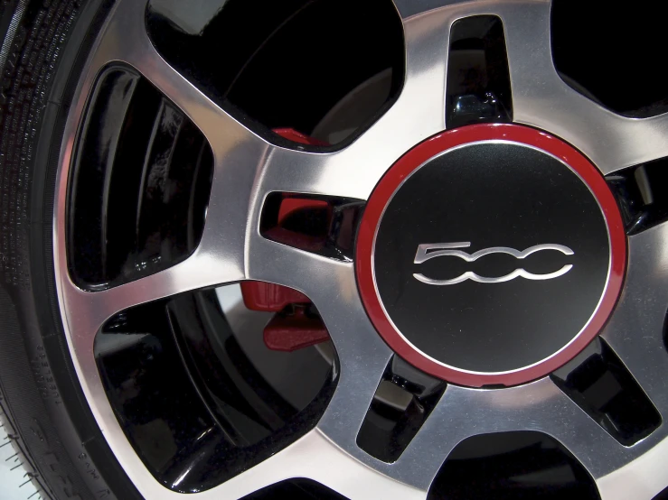 a shiny wheel with red lettering is shown