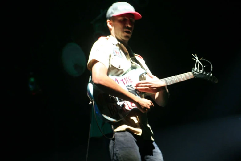 a person playing an electric guitar with a microphone