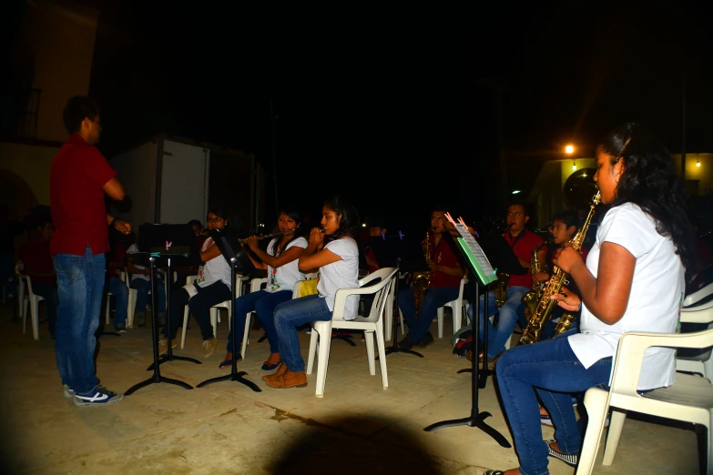 two saxophone players with guitar playing instruments on a patio