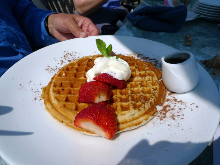 a plate filled with pancakes and covered in cream