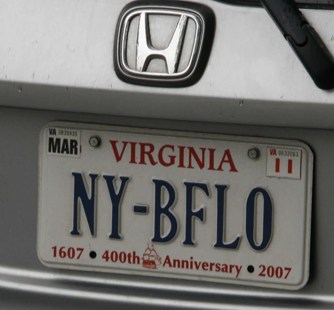 a white and red license plate attached to a car