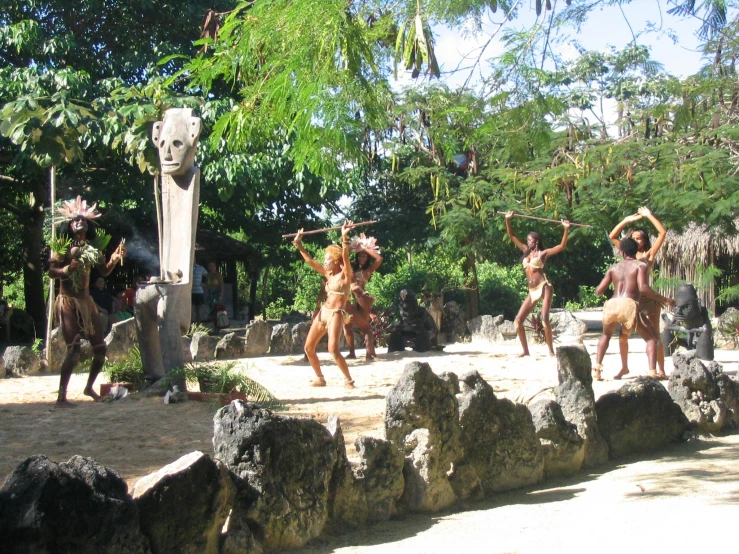 an image of a group of people dancing in the sand