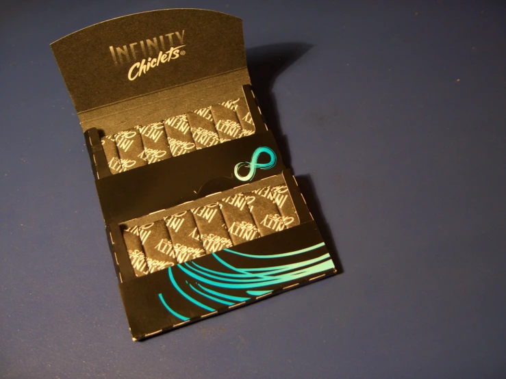 an unused box of matches with a green and blue design