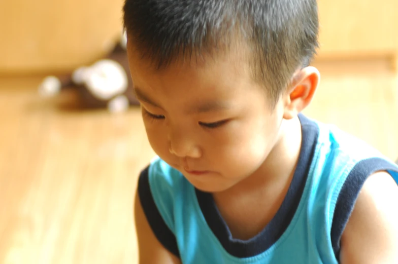 a small child playing with a cell phone on the floor