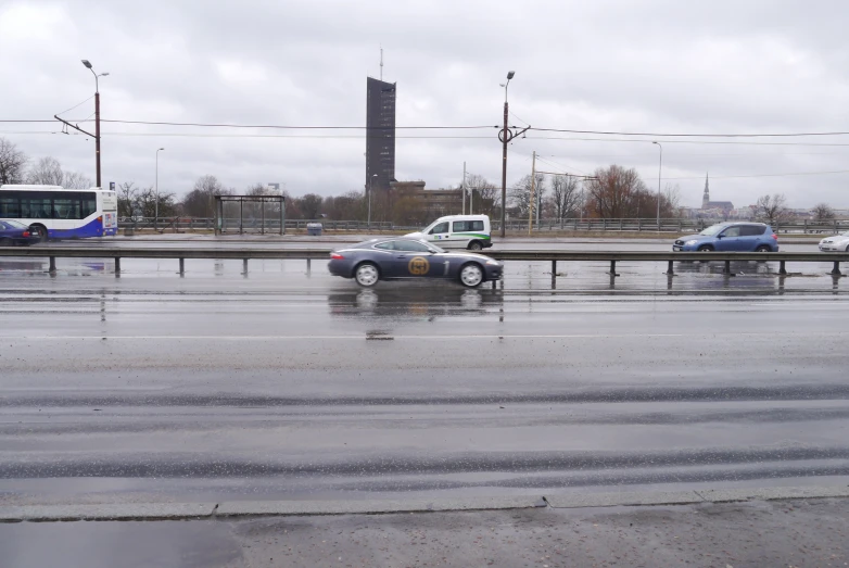 two cars in a parking lot with one van parked