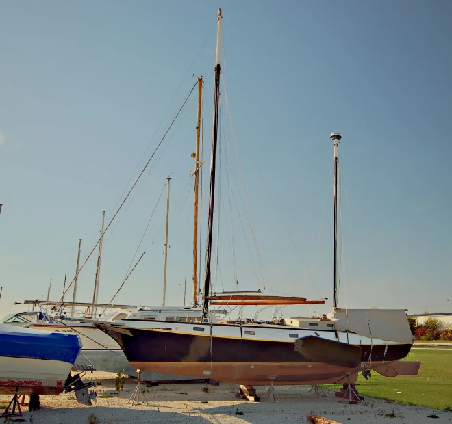 two large boats are parked on the beach