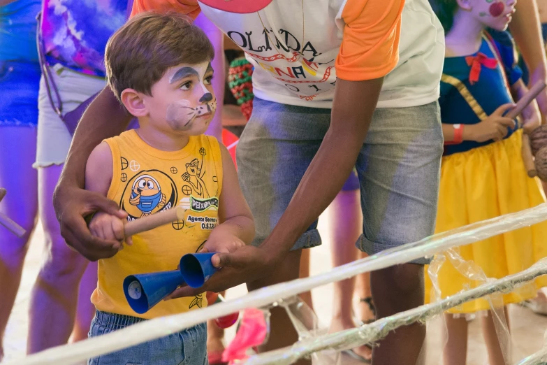 a little boy and a woman having their face painted