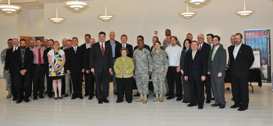 a group of people wearing suits and ties standing together