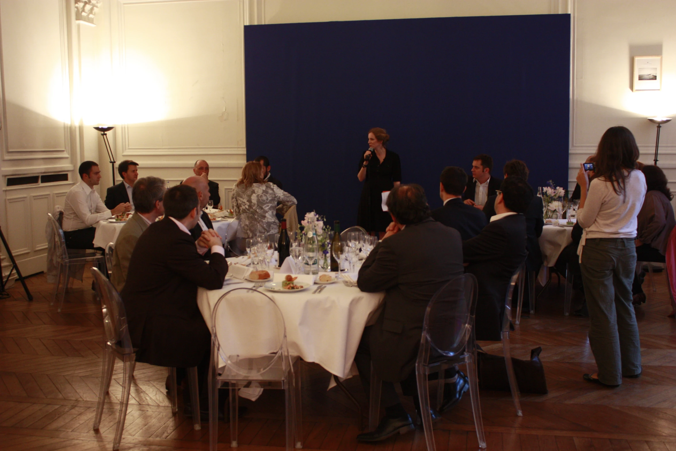 a group of people sitting around a table sharing food