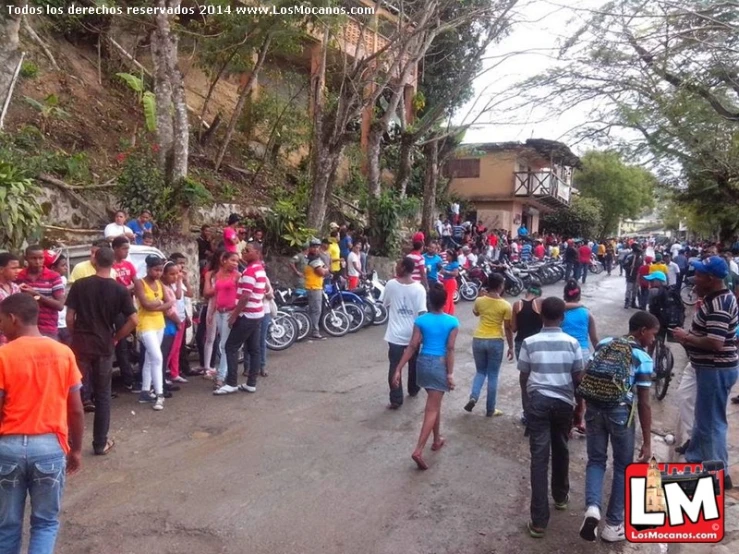 a crowd of people with bicycles on a road