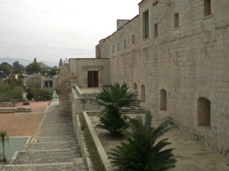 a bunch of bricks are piled in the corner to a stone building