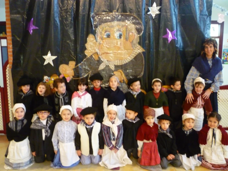 a group of children that are standing in front of a wall