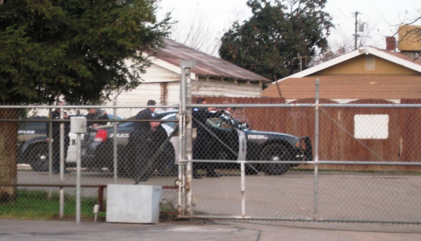 a truck that is parked in the street behind a fence