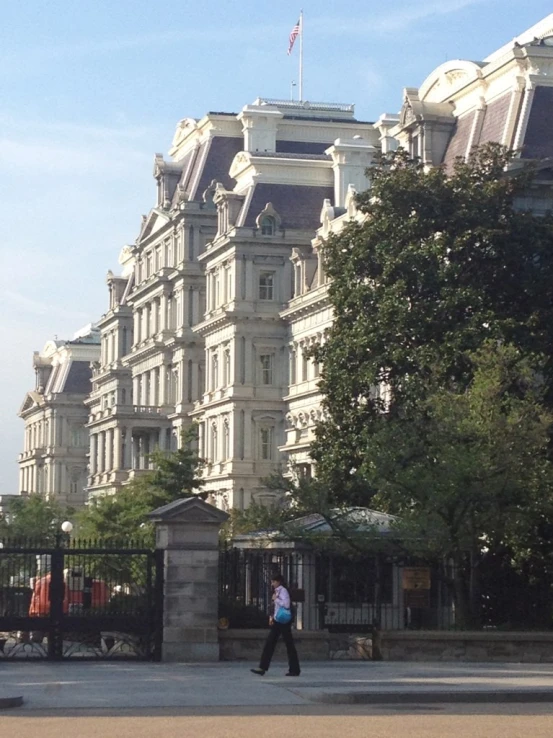 a man is standing in the middle of an empty lot next to some buildings