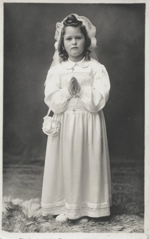 an old po of a little girl in a white dress