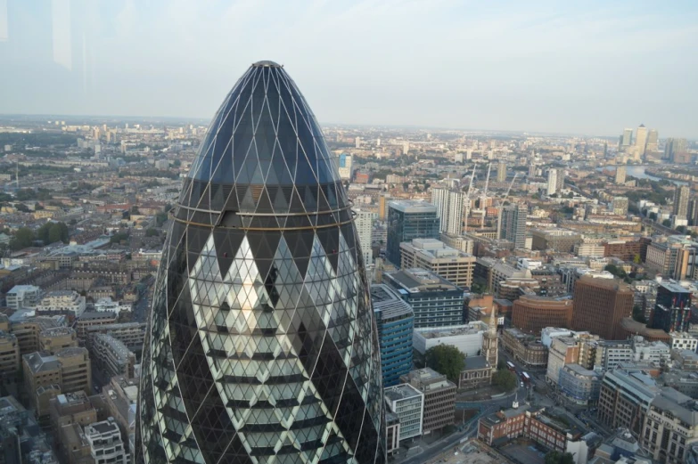 a very tall glass building towering over the city