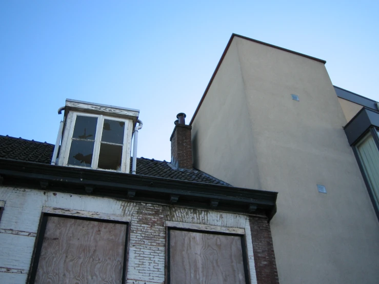 the top of an old brick building with doors open