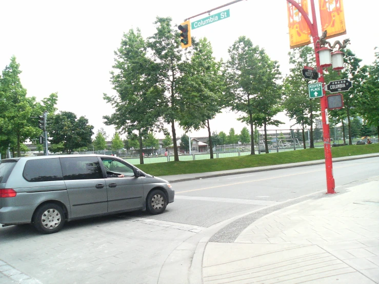 a van is stopped at a red stop light