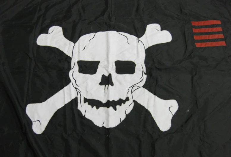 the black and white pirate skull flag is decorated with a red cross flag