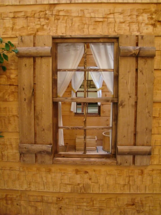 a rustic window in the wood paneled building