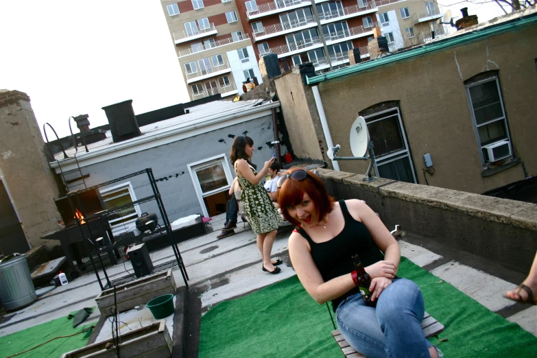 some people standing on the rooftop talking to each other