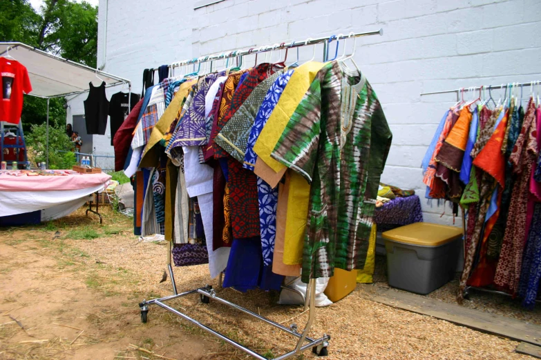 a rack of clothes on a street in a yard