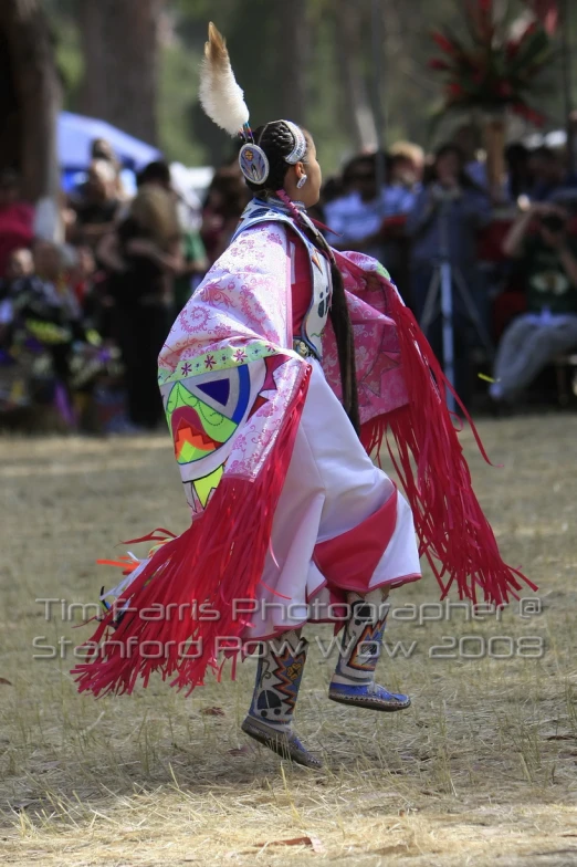 a man wearing a colorfully designed outfit and hat