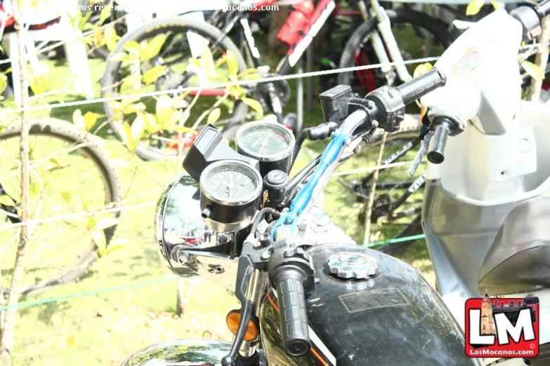 a motor bike parked by a fence in the field