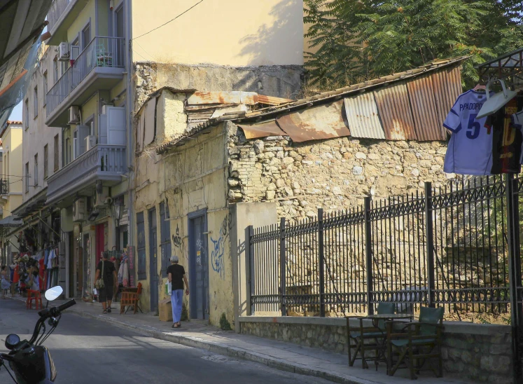 a street with buildings, bicycles, and people on the sidewalk