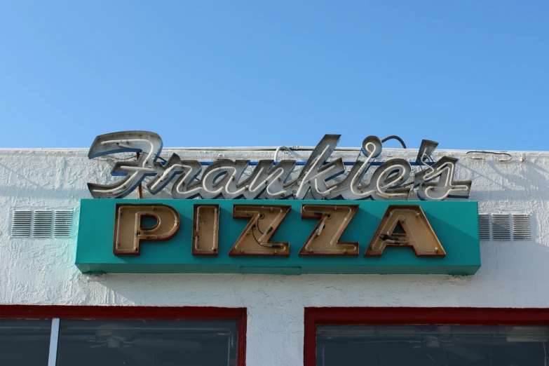 a sign that says franklins pizza above an open door