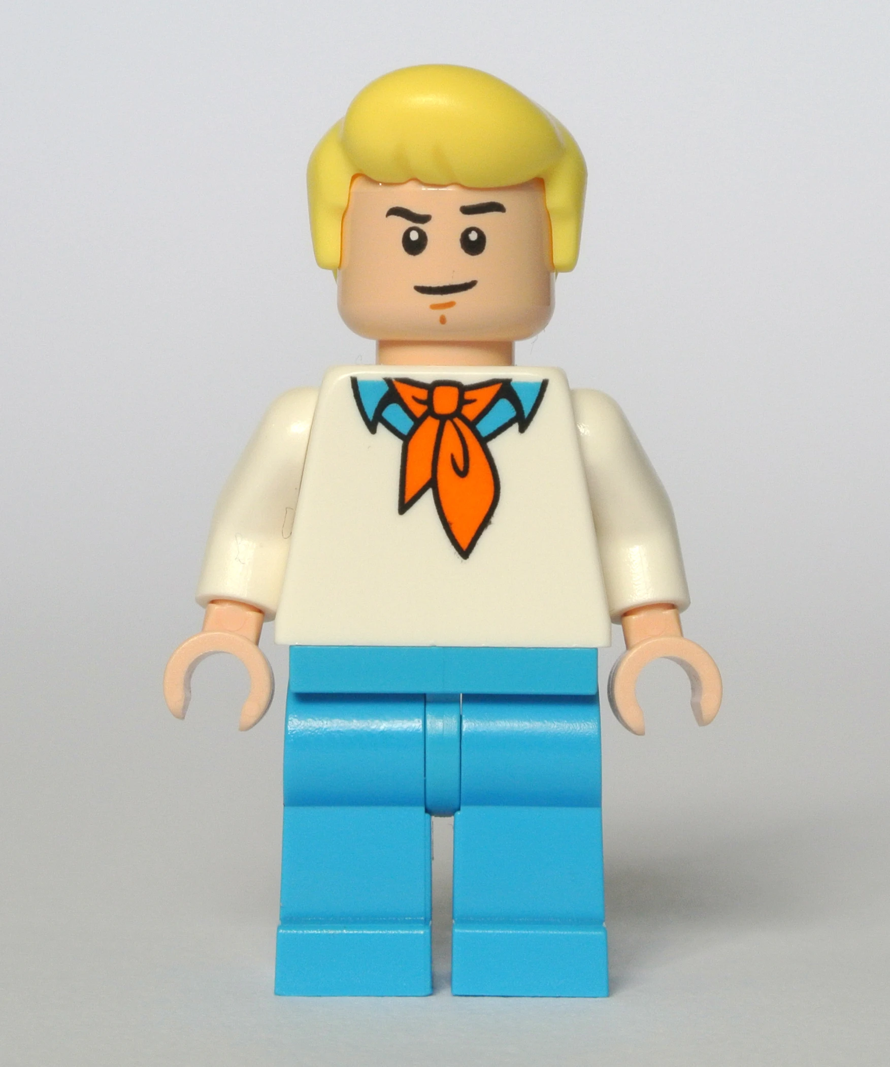 a white, yellow and blue lego man with yellow hair