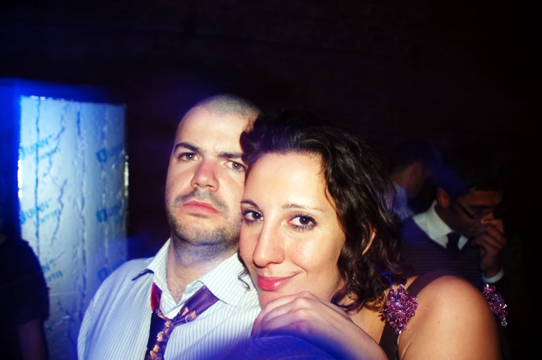 two people standing together at a nightclub