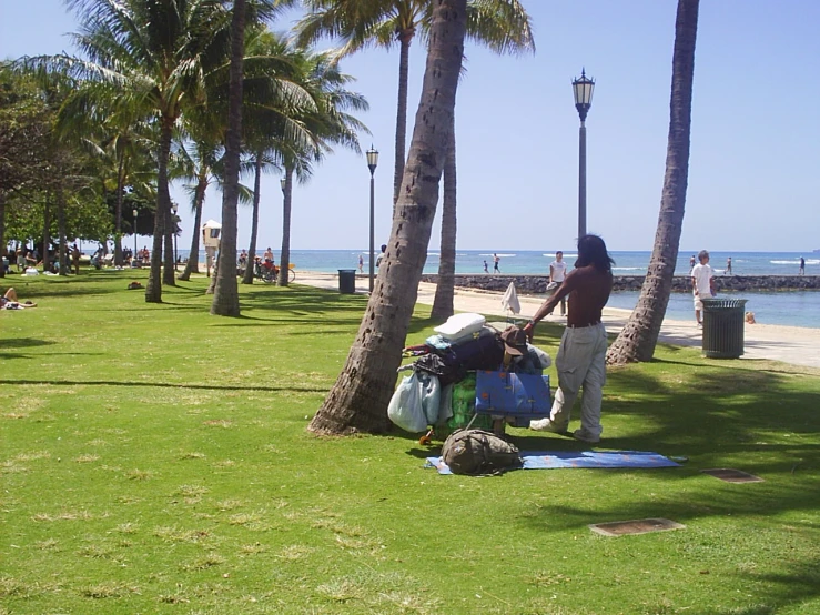 the man is cleaning off his clothes by the water